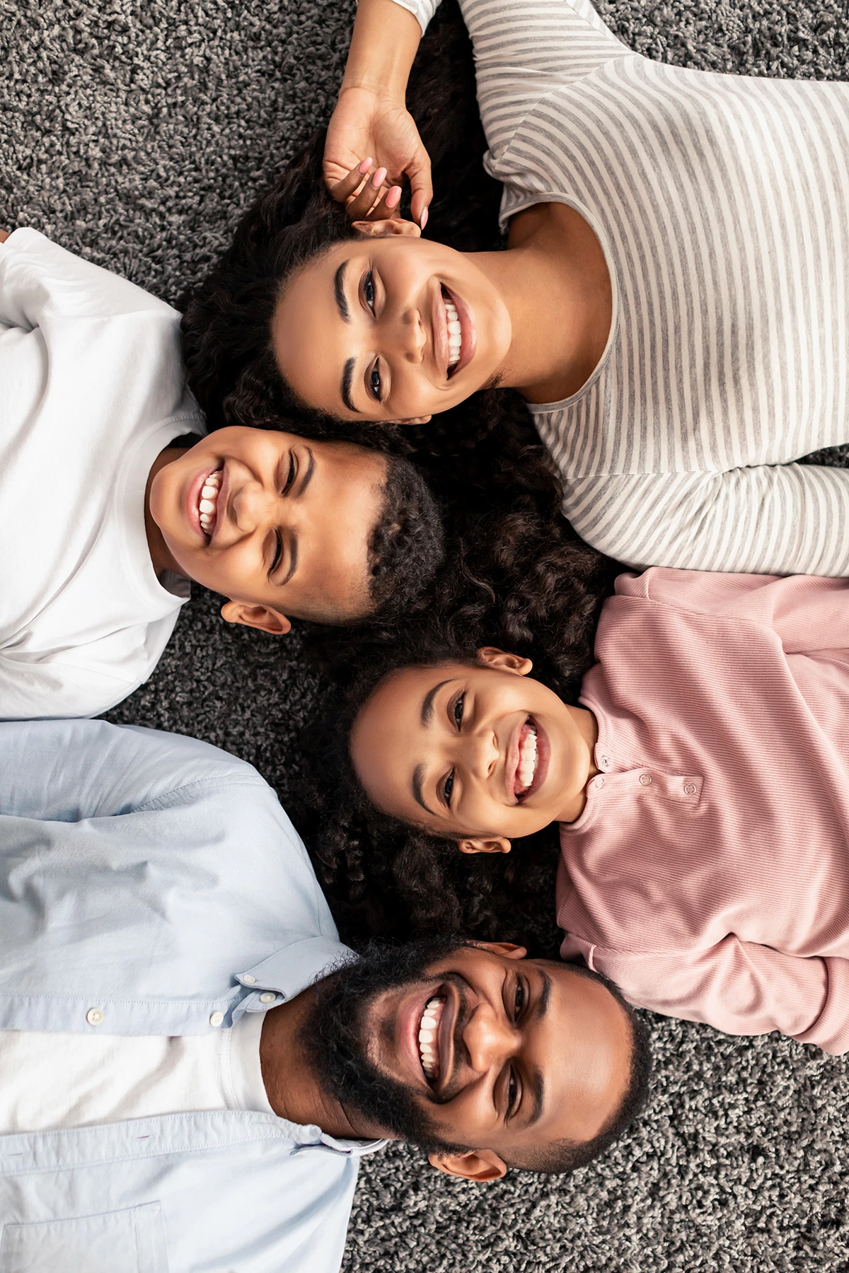 portrait-of-black-family-lying-on-floor-together portrait-of-black-family-lying-on-floor-together